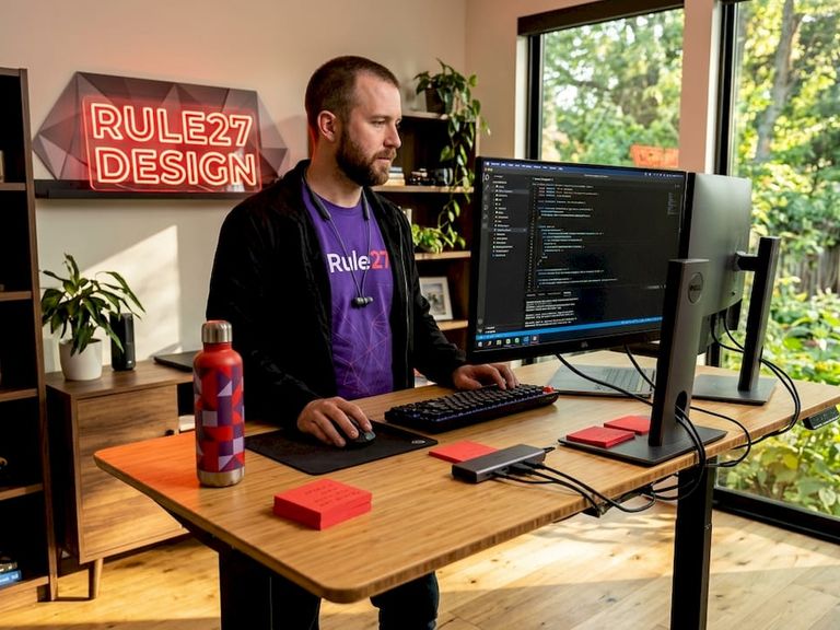 Developer working at dual monitors in open workspace